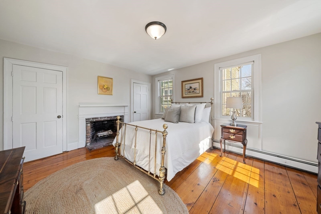 10 Summer Street, Unit 1 Boston, MA 02129 - Photo 16 of 37 a bed room with a bed and a fireplace