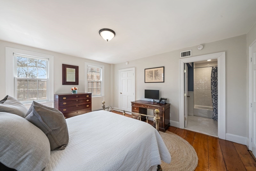 10 Summer Street, Unit 1 Boston, MA 02129 - Photo 18 of 37 a bedroom with a bed and wooden floor