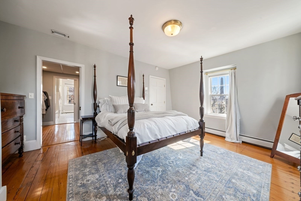 10 Summer Street, Unit 1 Boston, MA 02129 - Photo 22 of 37 a spacious bedroom with a bed and wooden floor