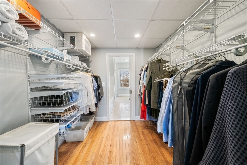 10 Summer Street, Unit 1 Boston, MA 02129 - Photo 23 of 37 a view of walk in closet with clothes and shoes
