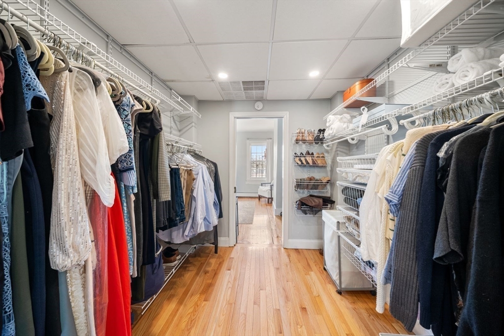 10 Summer Street, Unit 1 Boston, MA 02129 - Photo 24 of 37 a view of walk in closet with clothes and shoes
