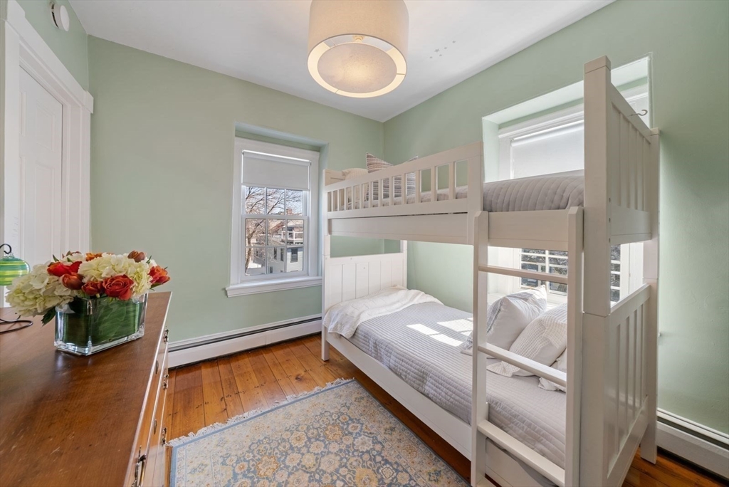 10 Summer Street, Unit 1 Boston, MA 02129 - Photo 28 of 37 a bedroom with a bed and a chandelier