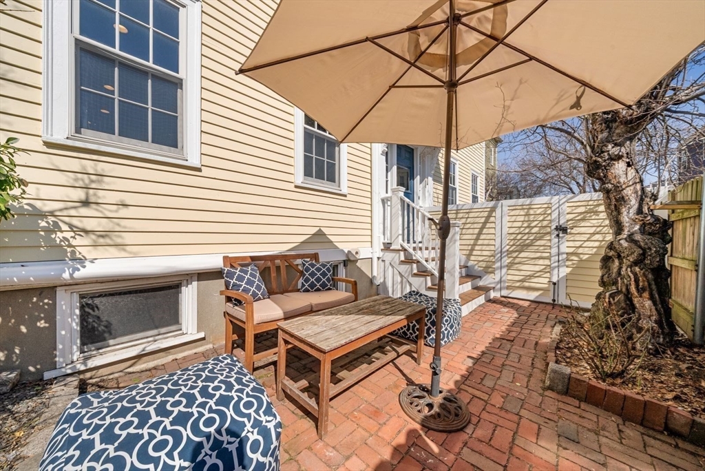 10 Summer Street, Unit 1 Boston, MA 02129 - Photo 29 of 37 a backyard of a house with wooden floor and outdoor seating