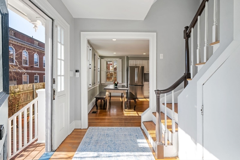 10 Summer Street, Unit 1 Boston, MA 02129 - Photo 5 of 37 a view of a hallway with large windows and stairs