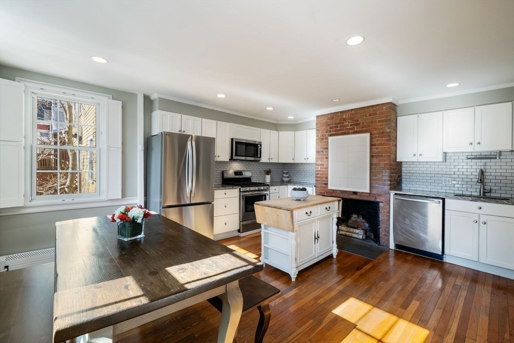 10 Summer Street, Unit 1 Boston, MA 02129 - Photo 7 of 37 a kitchen with stainless steel appliances granite countertop a refrigerator sink stove microwave and cabinets