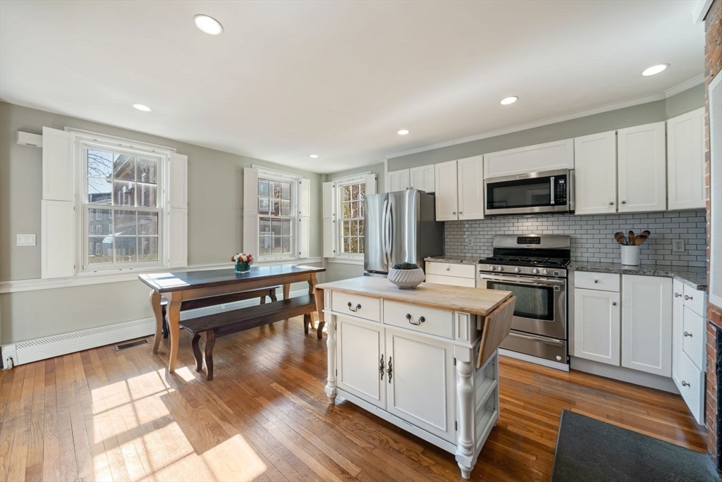 10 Summer Street, Unit 1 Boston, MA 02129 - Photo 8 of 37 a kitchen with a stove a sink and a microwave