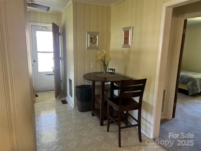 a view of a room that has a table and chair in it