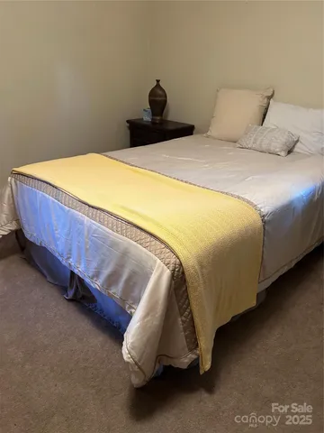 a bedroom with a bed and a wall painting