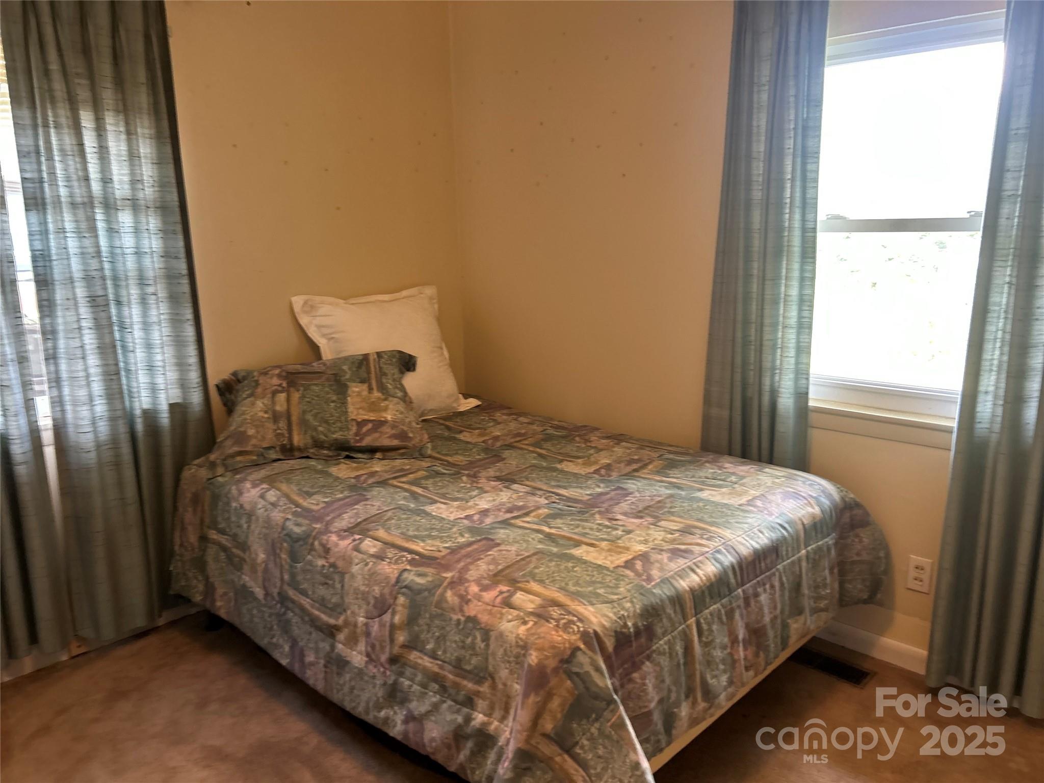 1401 Morven Road Wadesboro, NC 28170 - Photo 15 of 27 a large bed sitting in a bedroom next to a window