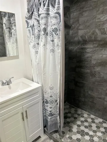 a bathroom with a shower and a sink