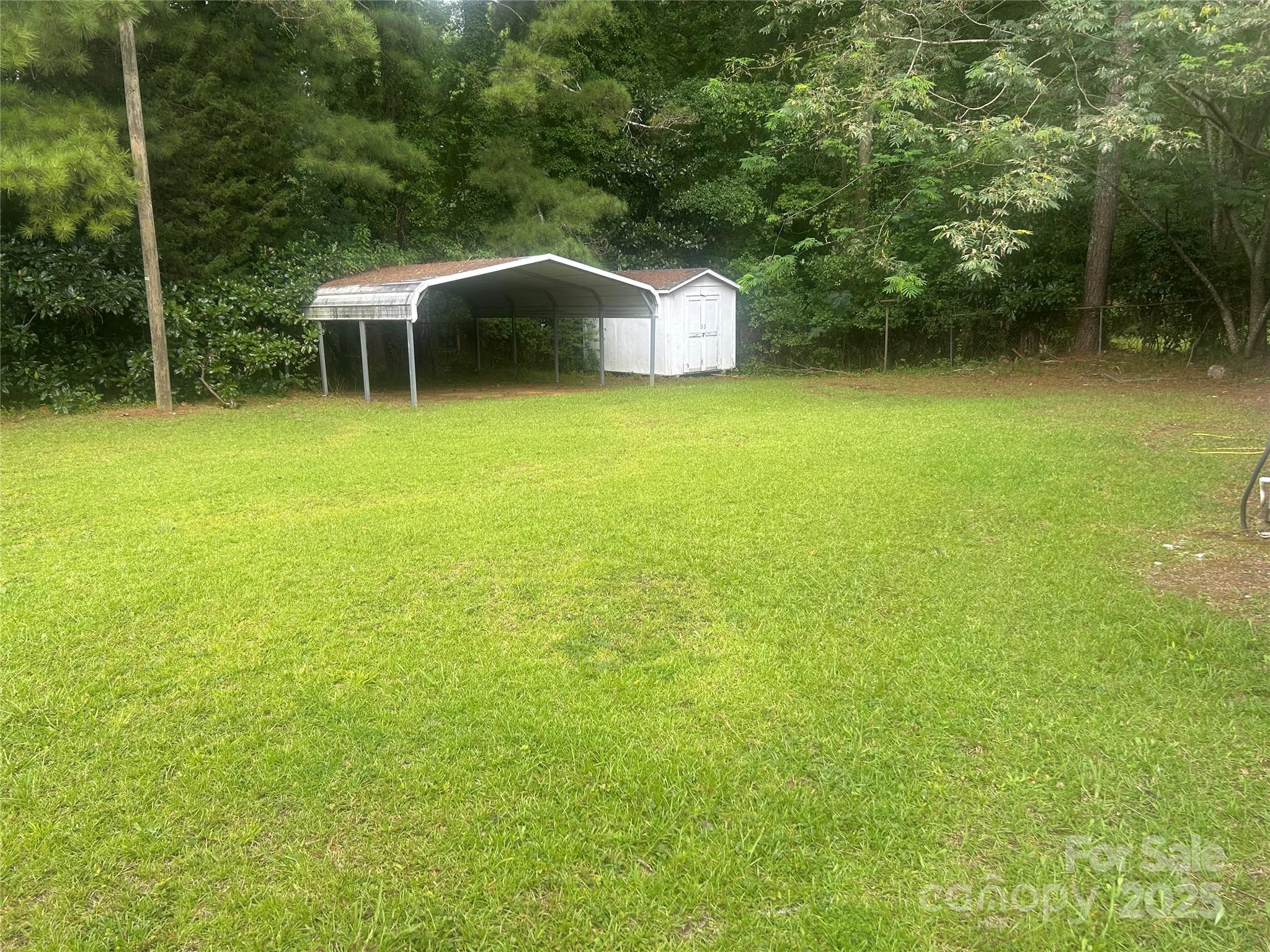 1401 Morven Road Wadesboro, NC 28170 - Photo 27 of 27 a view of a patio with table and chairs with wooden fence