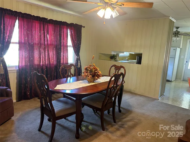 a dining room with furniture and window