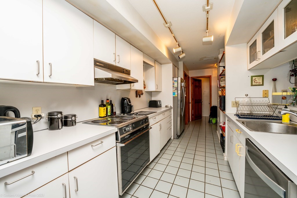 30 Wordell Street Rochester, MA 02770 - Photo 21 of 31 a kitchen with stainless steel appliances granite countertop a sink stove and refrigerator