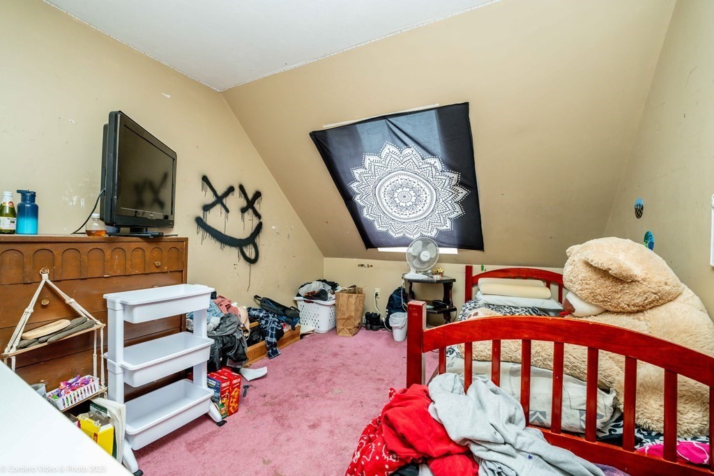 30 Wordell Street Rochester, MA 02770 - Photo 29 of 31 a bedroom with furniture and a flat screen tv