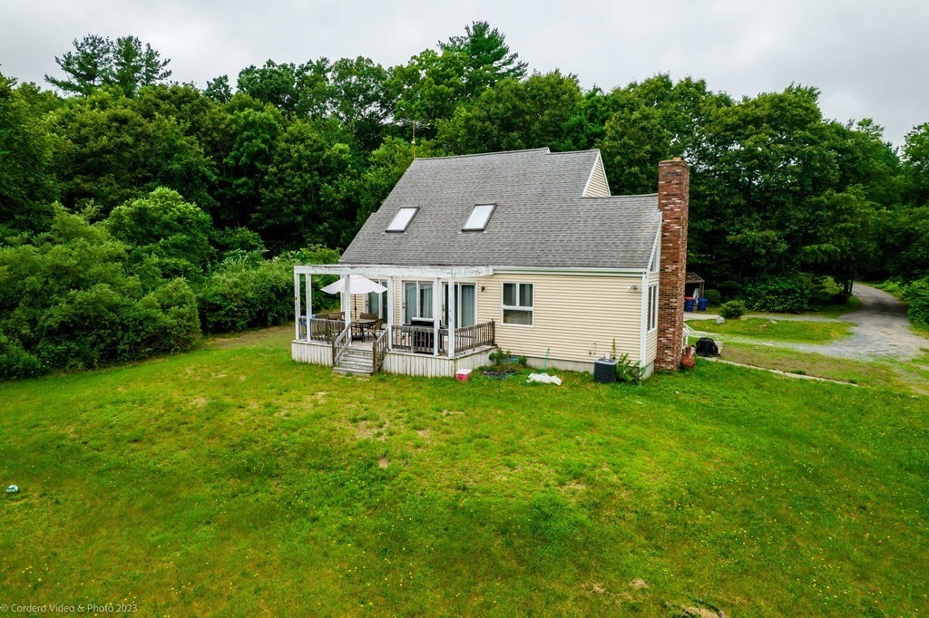 30 Wordell Street Rochester, MA 02770 - Photo 4 of 31 a aerial view of a house with a yard table and chairs