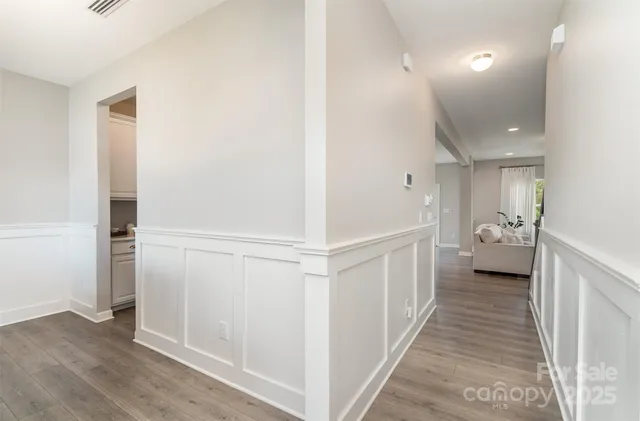 a view of a hallway with a livingroom and a bathroom