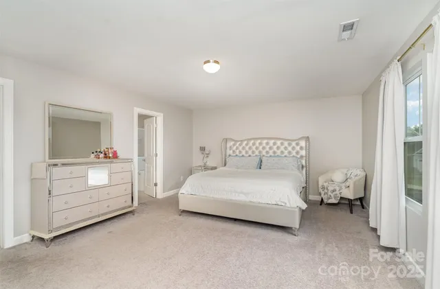 a room with a bed and a dresser