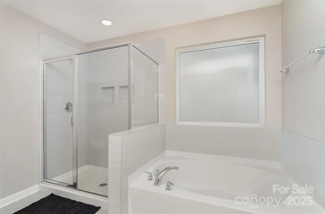 a bathroom with a bathtub and a shower