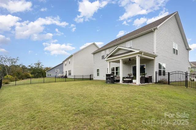 a view of a house with a yard and sitting area