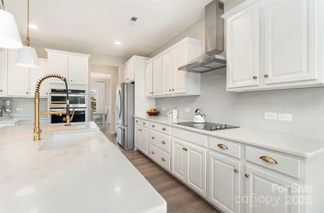 a kitchen with cabinets appliances and a counter space