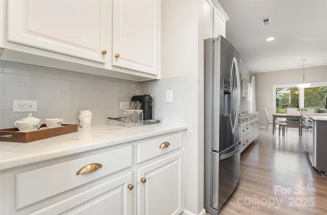 a kitchen with a sink stainless steel appliances and cabinets