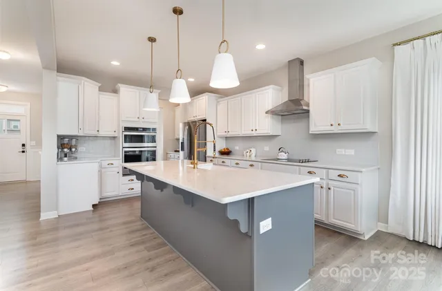 a kitchen with kitchen island white cabinets and white appliances