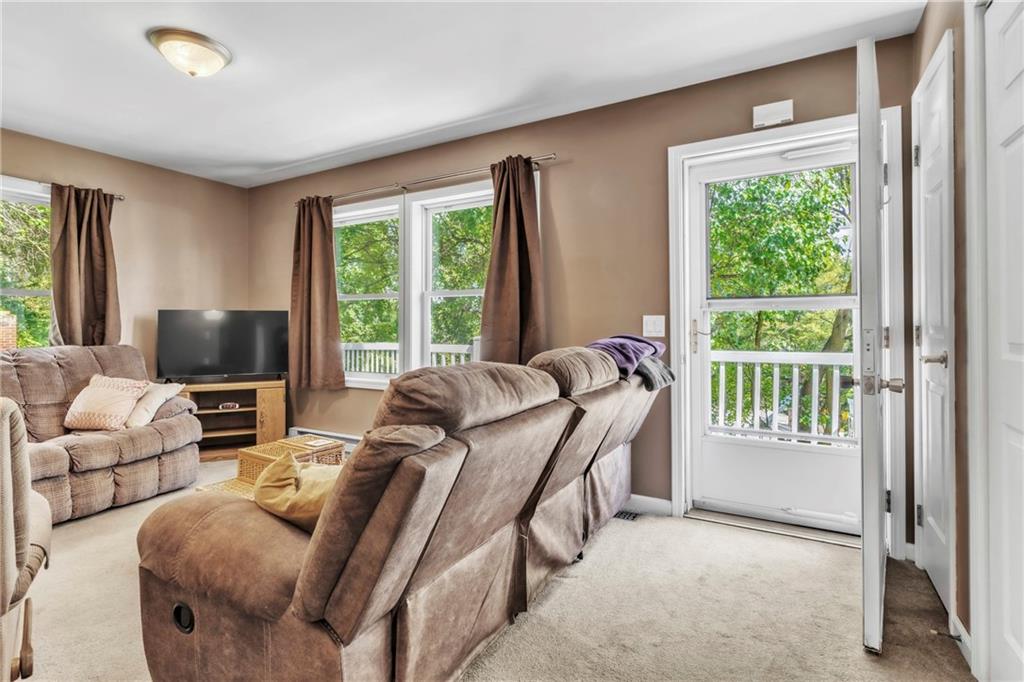 120 West Catherine Street Somerset, PA 15501 - Photo 10 of 31 a living room with furniture a flat screen tv and a large window