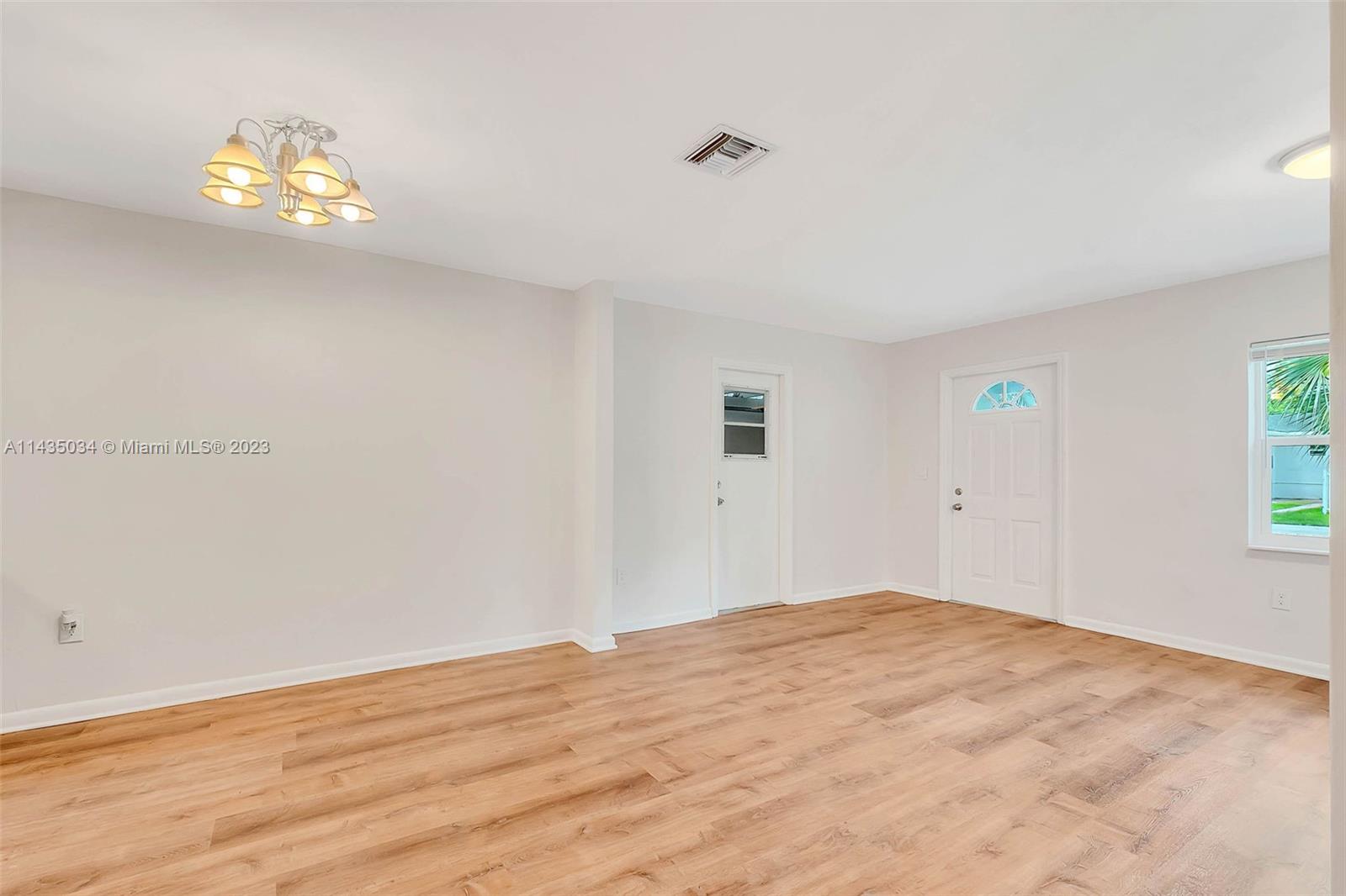 1023 Northwest 3rd Avenue Homestead, FL 33030 - Photo 12 of 32 a view of empty room with wooden floor