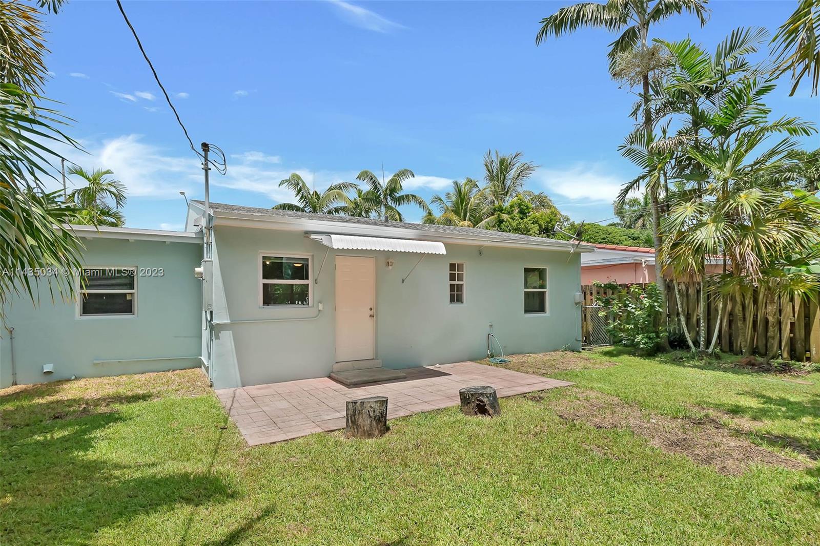 1023 Northwest 3rd Avenue Homestead, FL 33030 - Photo 21 of 32 a backyard of a house with table and chairs