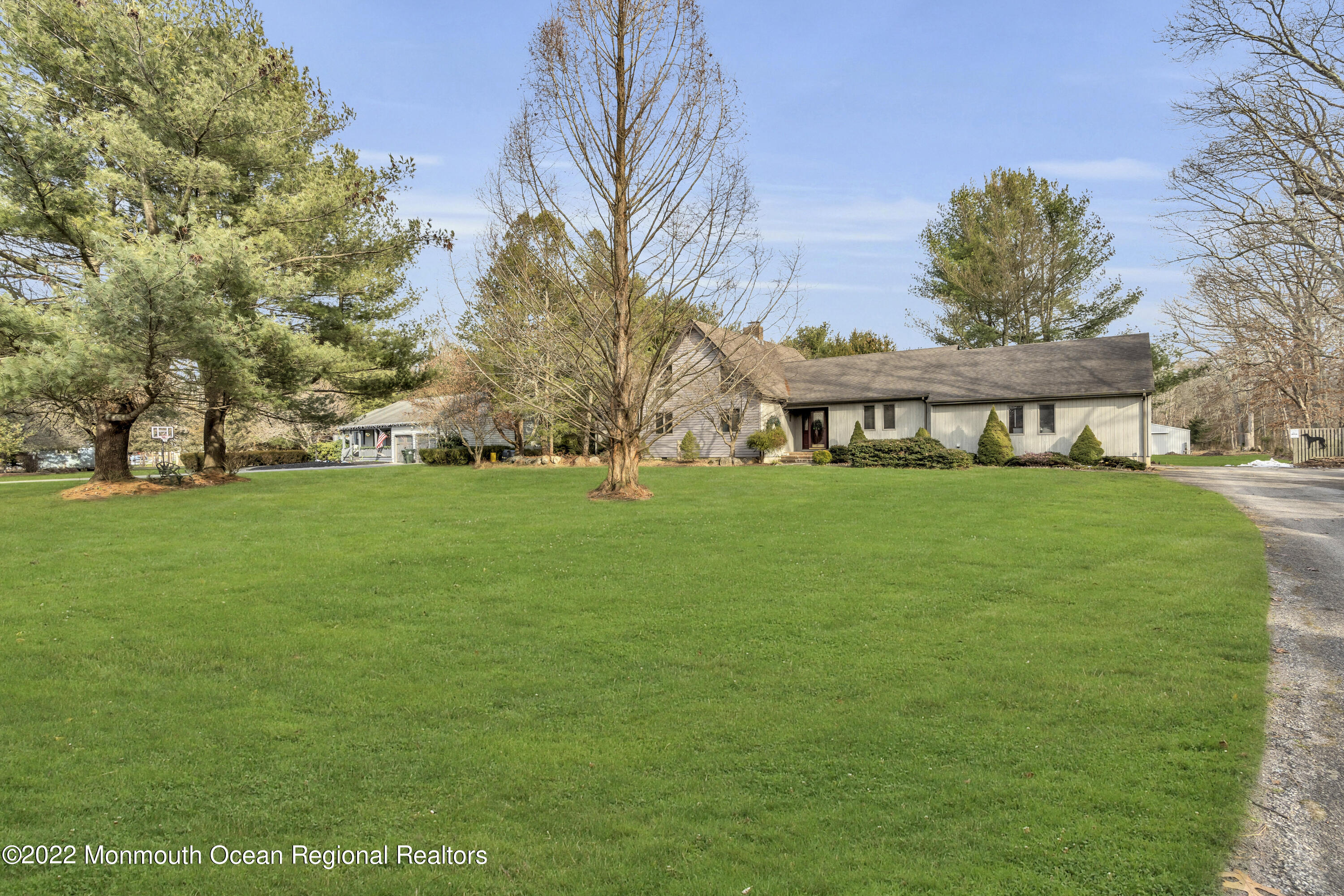 39 Johnson Lane Jackson, NJ 08527 - Photo 4 of 47 a view of a white house with a big yard and large trees
