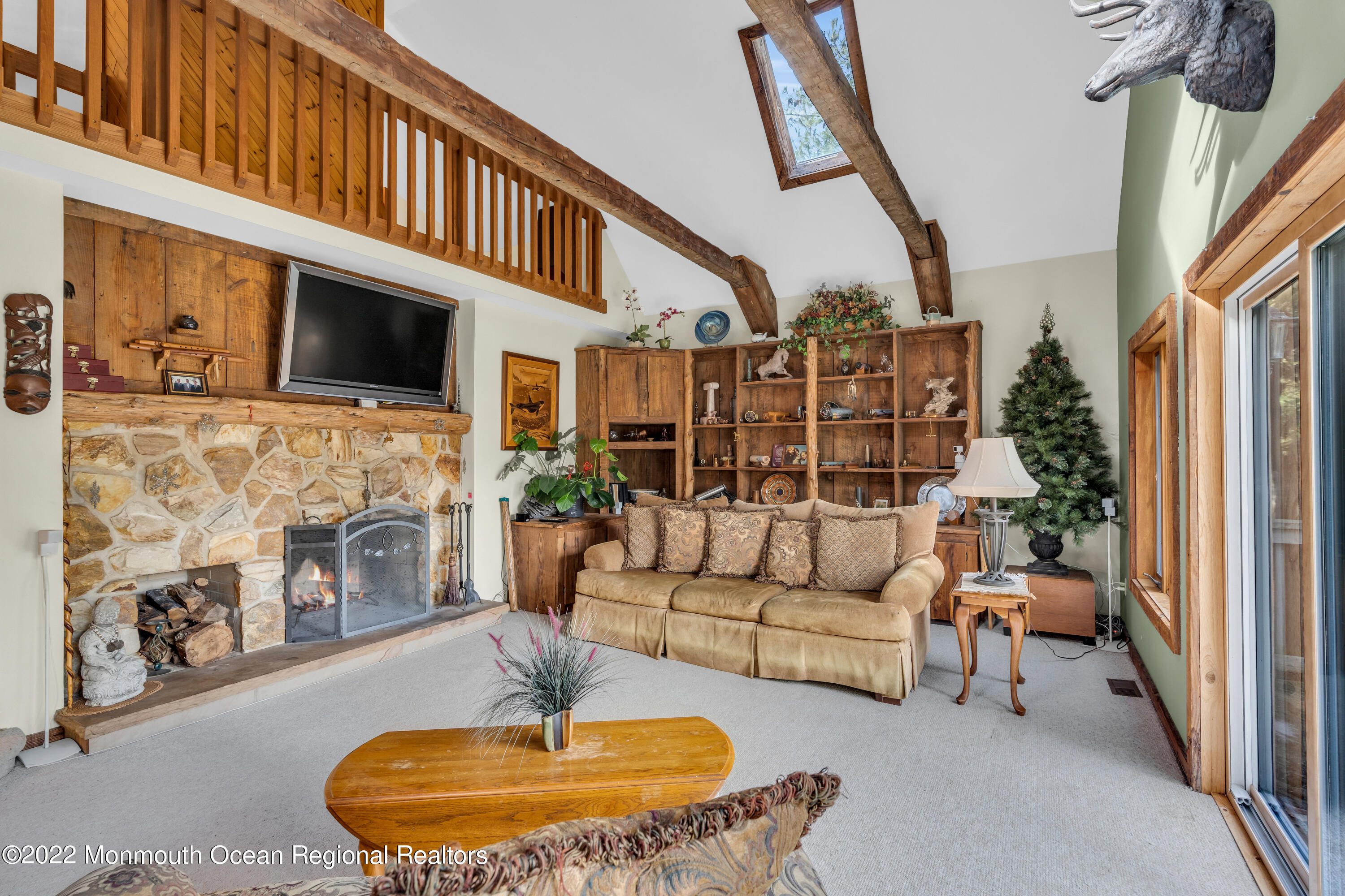 39 Johnson Lane Jackson, NJ 08527 - Photo 9 of 47 a living room with furniture a flat screen tv and a fireplace