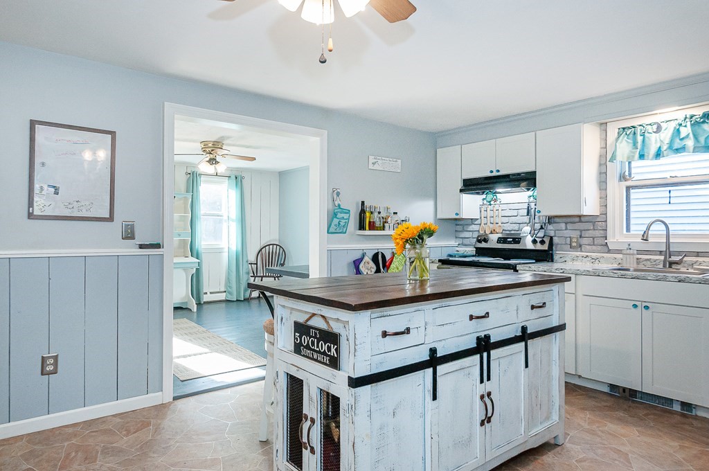 133 High Street Rochester, MA 02770 - Photo 17 of 38 a kitchen with stainless steel appliances a stove a sink dishwasher and cabinets with wooden floor
