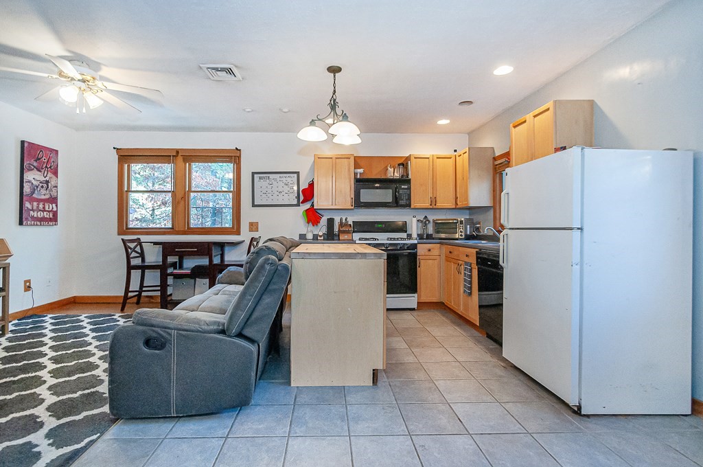 133 High Street Rochester, MA 02770 - Photo 23 of 38 a kitchen with a refrigerator a microwave oven a sink dishwasher and white cabinets with wooden floor