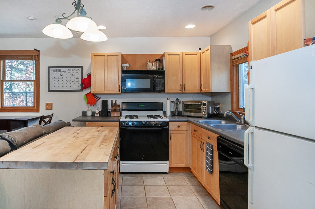 133 High Street Rochester, MA 02770 - Photo 24 of 38 a kitchen with stainless steel appliances a stove refrigerator sink and a microwave