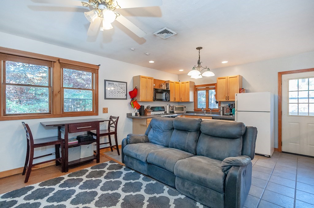 133 High Street Rochester, MA 02770 - Photo 26 of 38 a living room with furniture a chandelier and a dining table