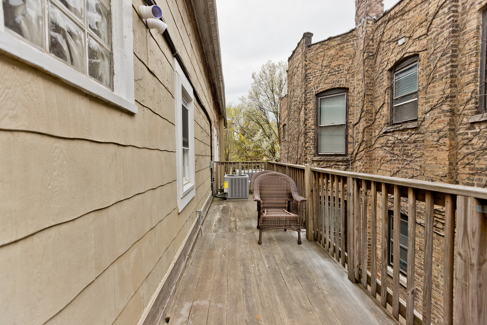 1300 West Addison Street, Unit 1 Chicago, IL 60613 - Photo 14 of 14 a view of a balcony with wooden floor and fence