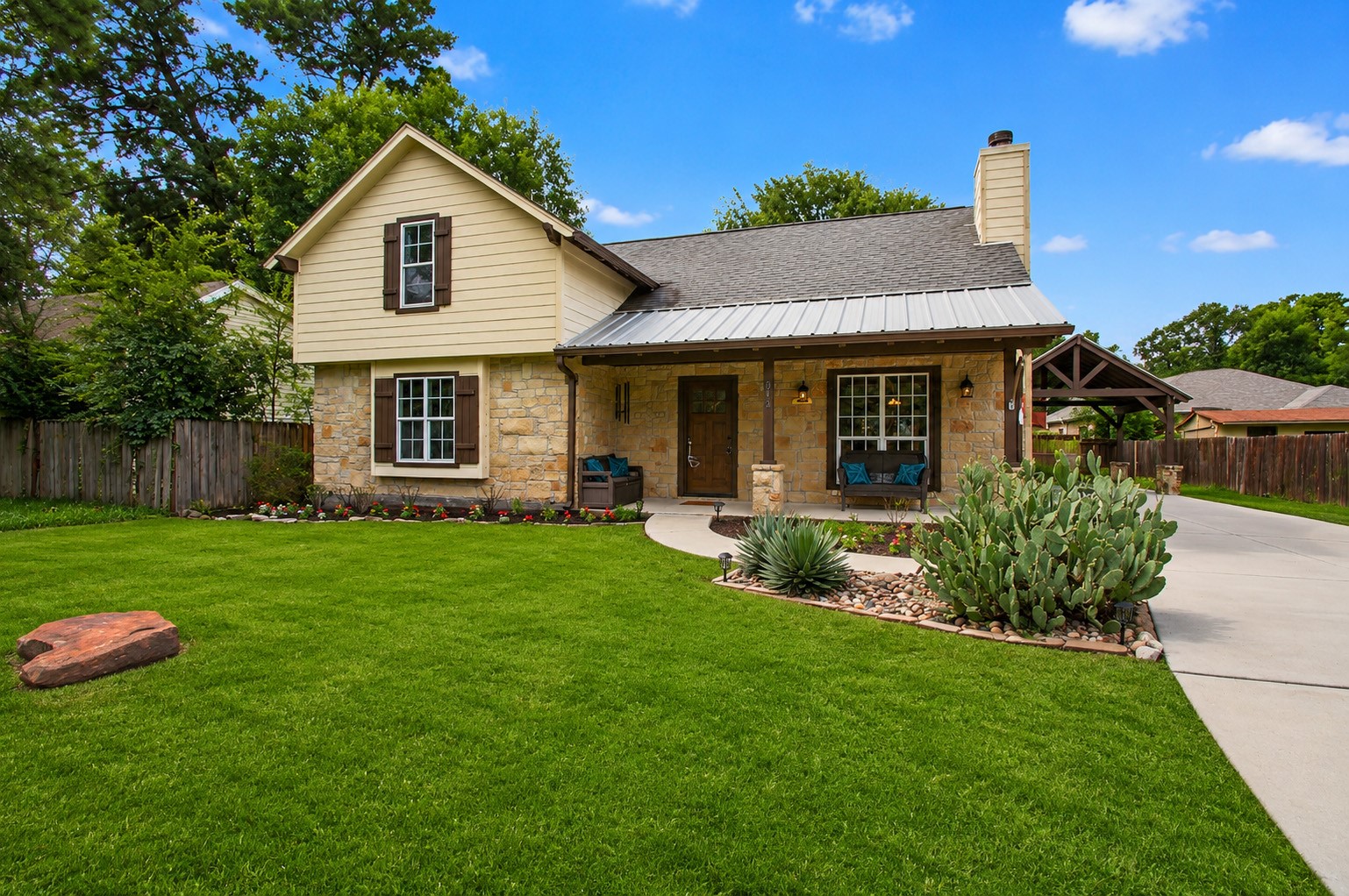 312 Springwood Drive Conroe, TX 77385 - Photo 2 of 50 The lovely exterior welcomes you home with a covered front porch, custom carport and attractive landscaping.