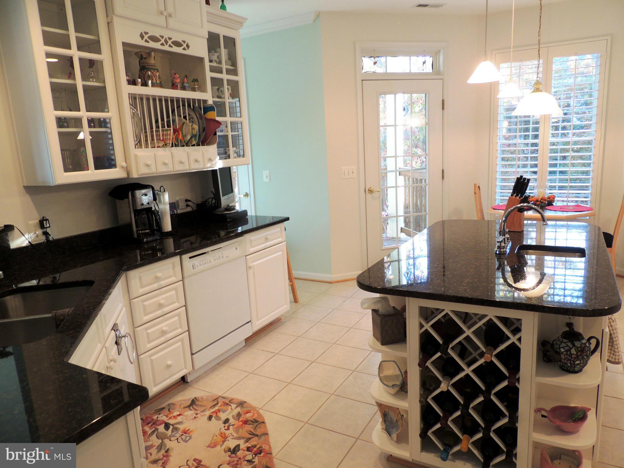 722 Runabout Loop, Unit 722 Solomons, MD 20688 - Photo 10 of 30 a kitchen with a sink a stove and a wooden floor