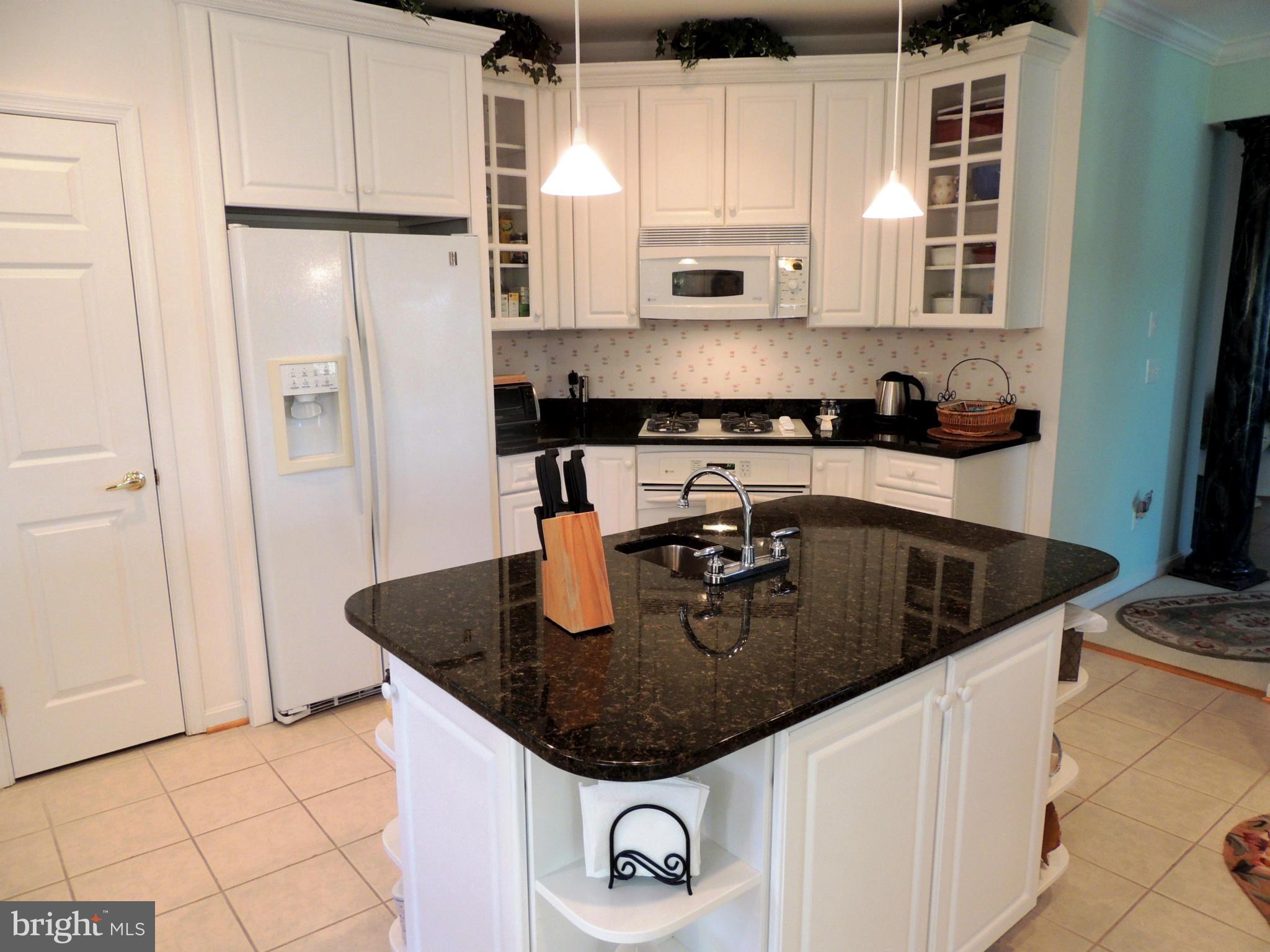 722 Runabout Loop, Unit 722 Solomons, MD 20688 - Photo 12 of 30 a kitchen with stainless steel appliances granite countertop a sink a refrigerator and a stove