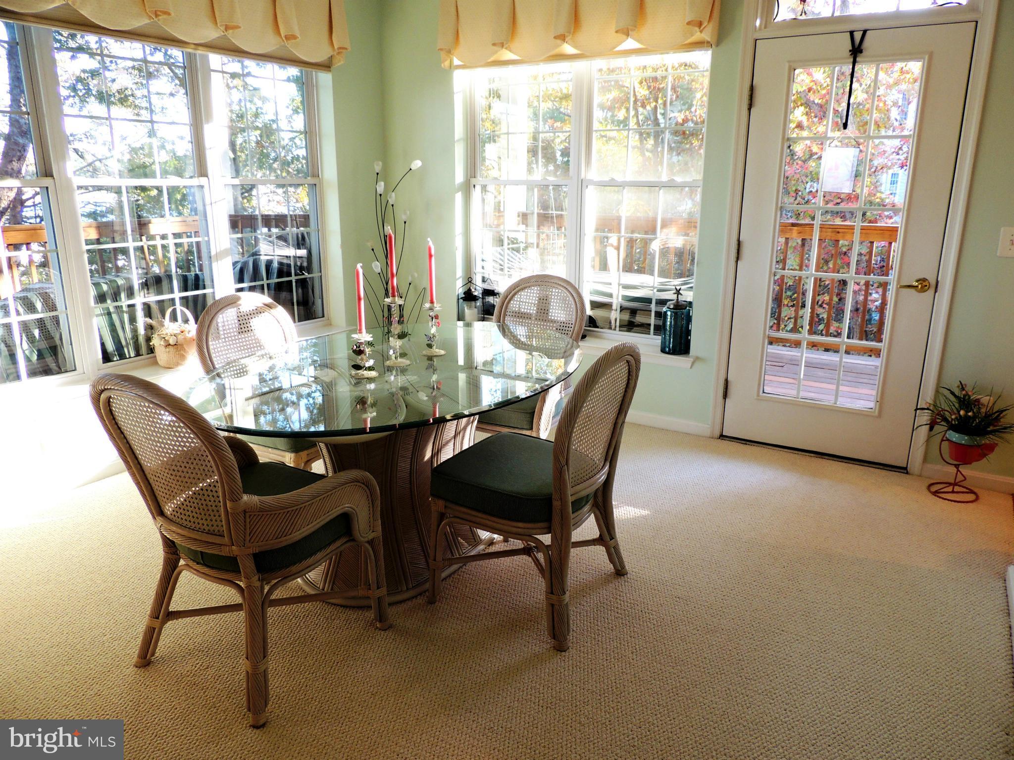 722 Runabout Loop, Unit 722 Solomons, MD 20688 - Photo 14 of 30 a dining room with furniture and a floor to ceiling window