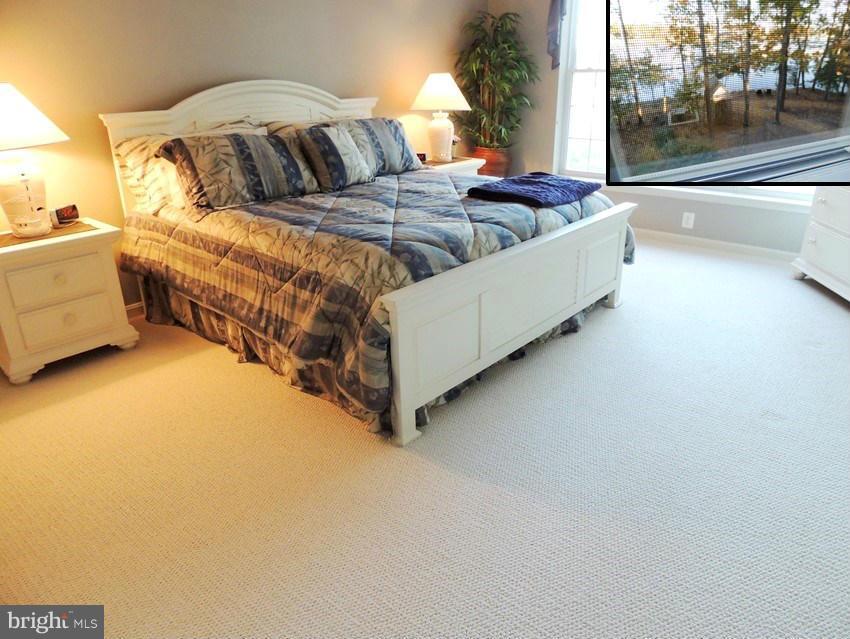 722 Runabout Loop, Unit 722 Solomons, MD 20688 - Photo 15 of 30 a bedroom with a bed couch and window