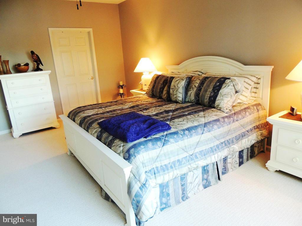 722 Runabout Loop, Unit 722 Solomons, MD 20688 - Photo 16 of 30 a bedroom with a bed and a couch