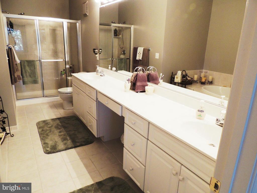 722 Runabout Loop, Unit 722 Solomons, MD 20688 - Photo 17 of 30 a bathroom with a sink and a mirror