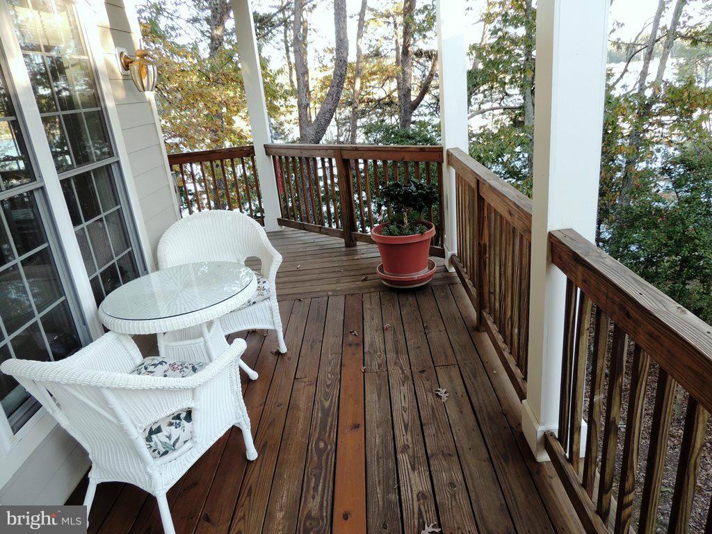 722 Runabout Loop, Unit 722 Solomons, MD 20688 - Photo 7 of 30 a view of balcony with wooden floor and outdoor seating