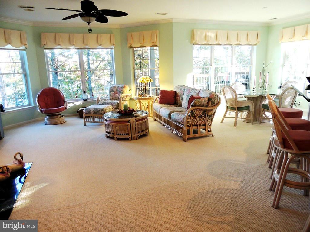 722 Runabout Loop, Unit 722 Solomons, MD 20688 - Photo 30 of 30 a living room with furniture and floor to ceiling windows