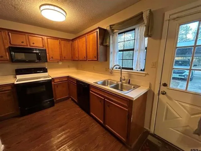 a kitchen with a sink stove and microwave