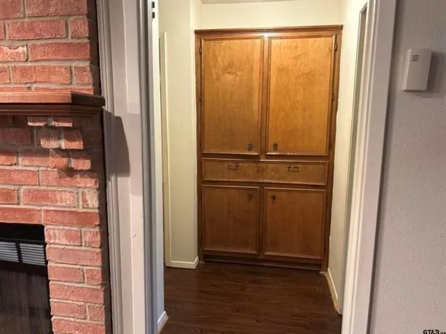a view of a closet area with wooden floor