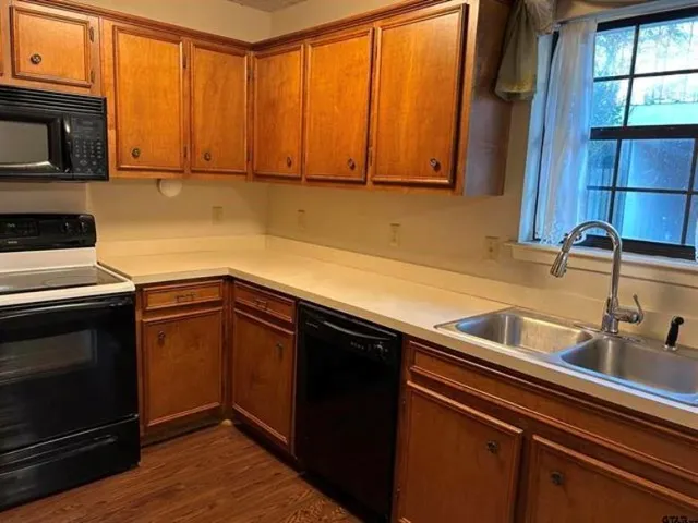 a kitchen with a sink cabinets and stainless steel appliances