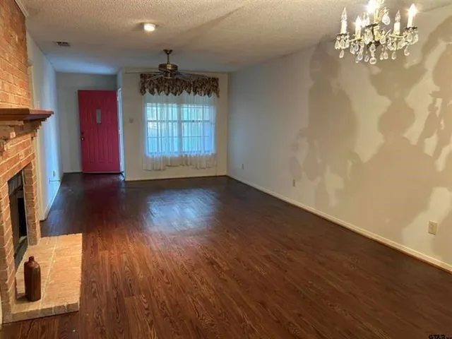 wooden floor in an empty room with a fireplace
