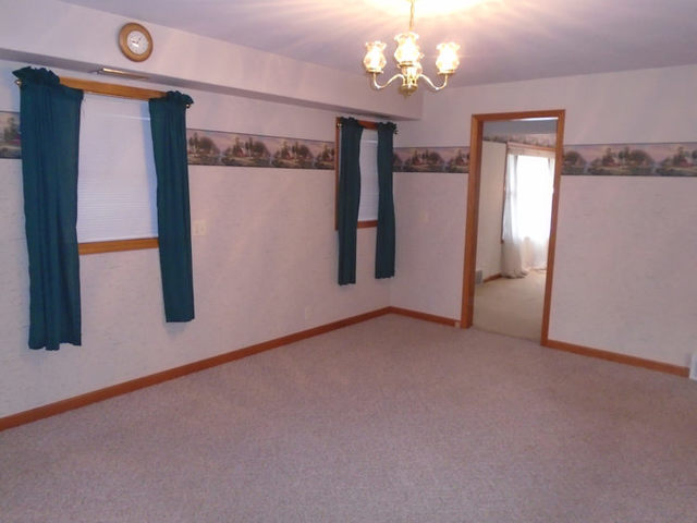 2048 Highway 251 Rochelle, IL 61068 - Photo 5 of 17 en empty room with windows and ceiling fan